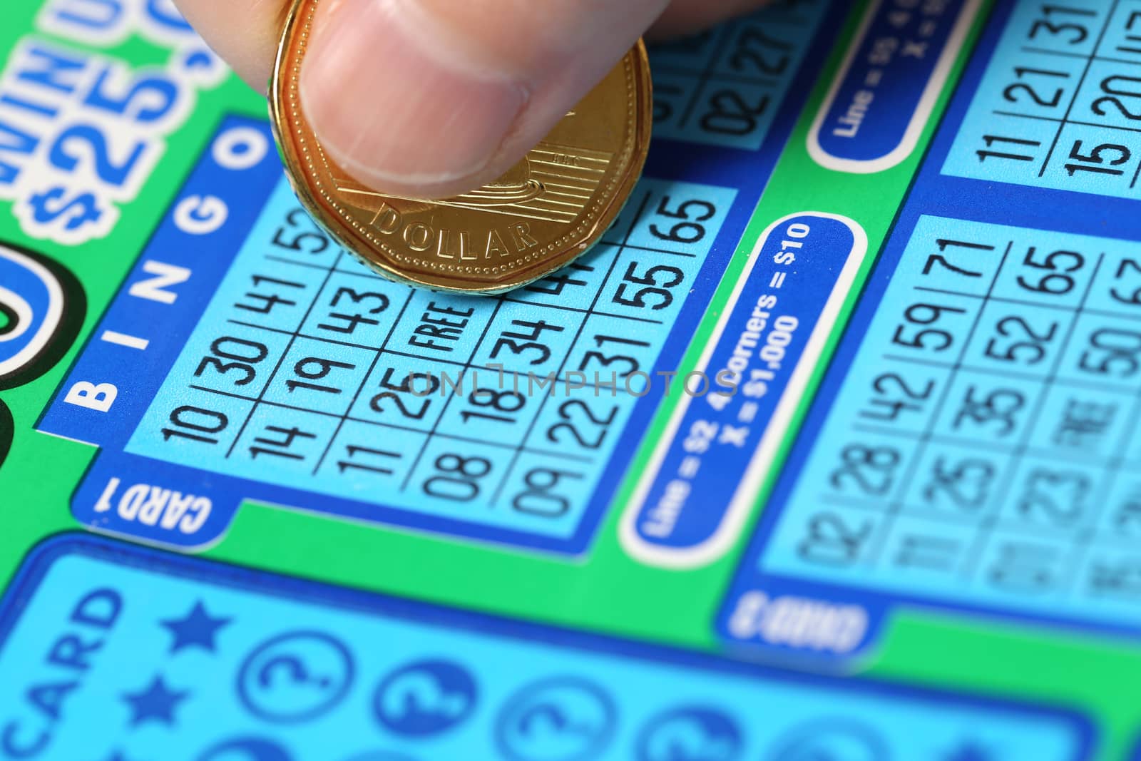 Coquitlam BC Canada - June 15, 2014 : Woman scratching lottery ticket called Bingo. It's published by BC Lottery Corporation has provided government sanctioned lottery games.