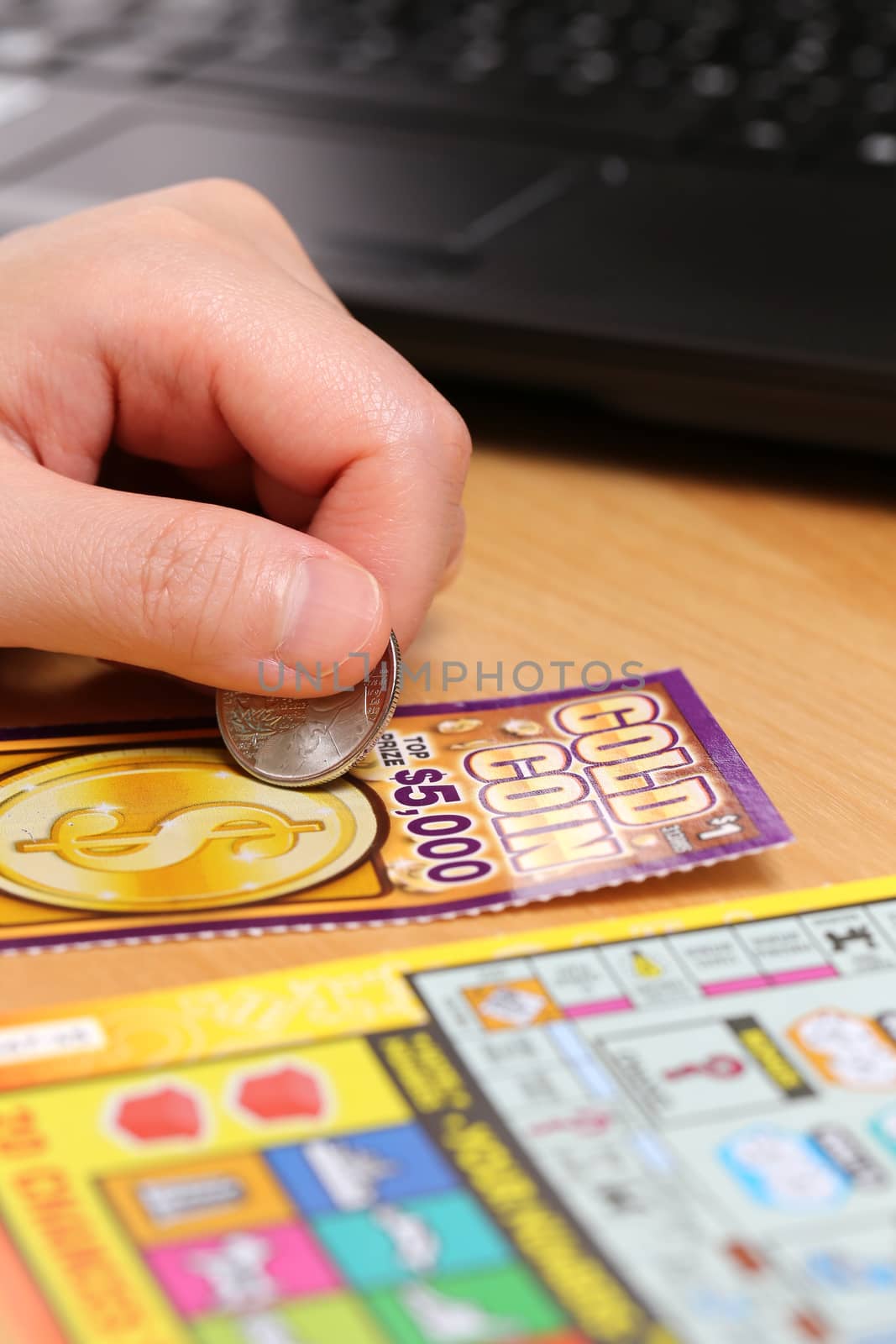 COQUITLAM, BC, CANADA - June 15, 2014 : Scratching lottery tickets. The British Columbia Lottery Corporation has provided government sanctioned lottery games in British Columbia since 1985. 