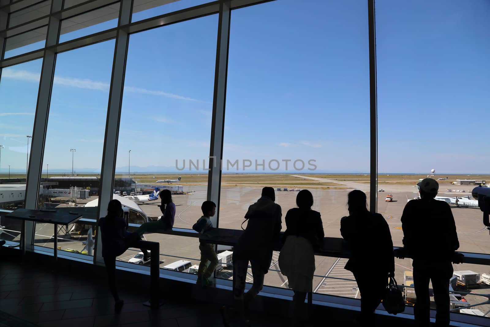 Vancouver, BC Canada - September 13,  2014 : People inside YVR airport watching air canada airplane in Vancouver BC Canada. 