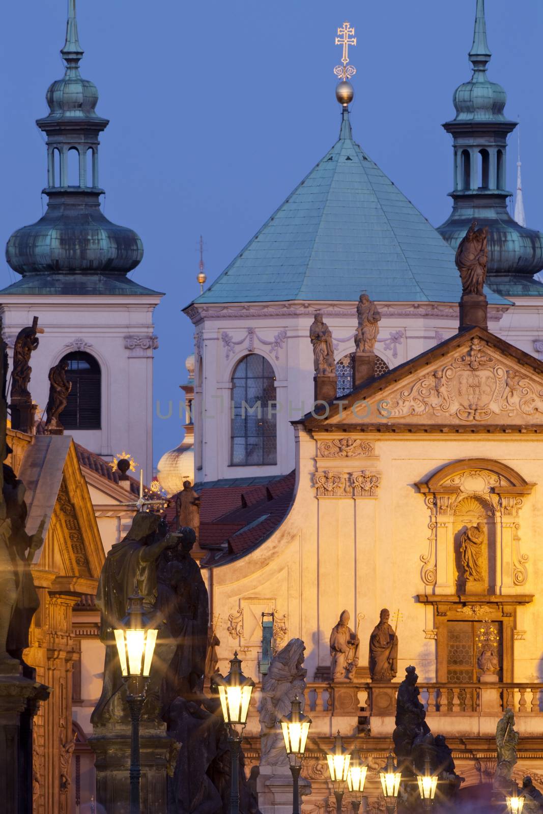 prague - religious art on charles bridge, lanterns and spires of the old town