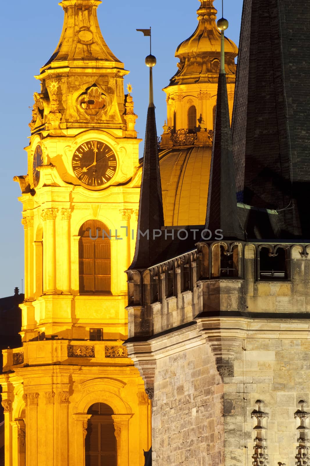 prague - different architectural styles-st. nicolas church and charles bridge tower