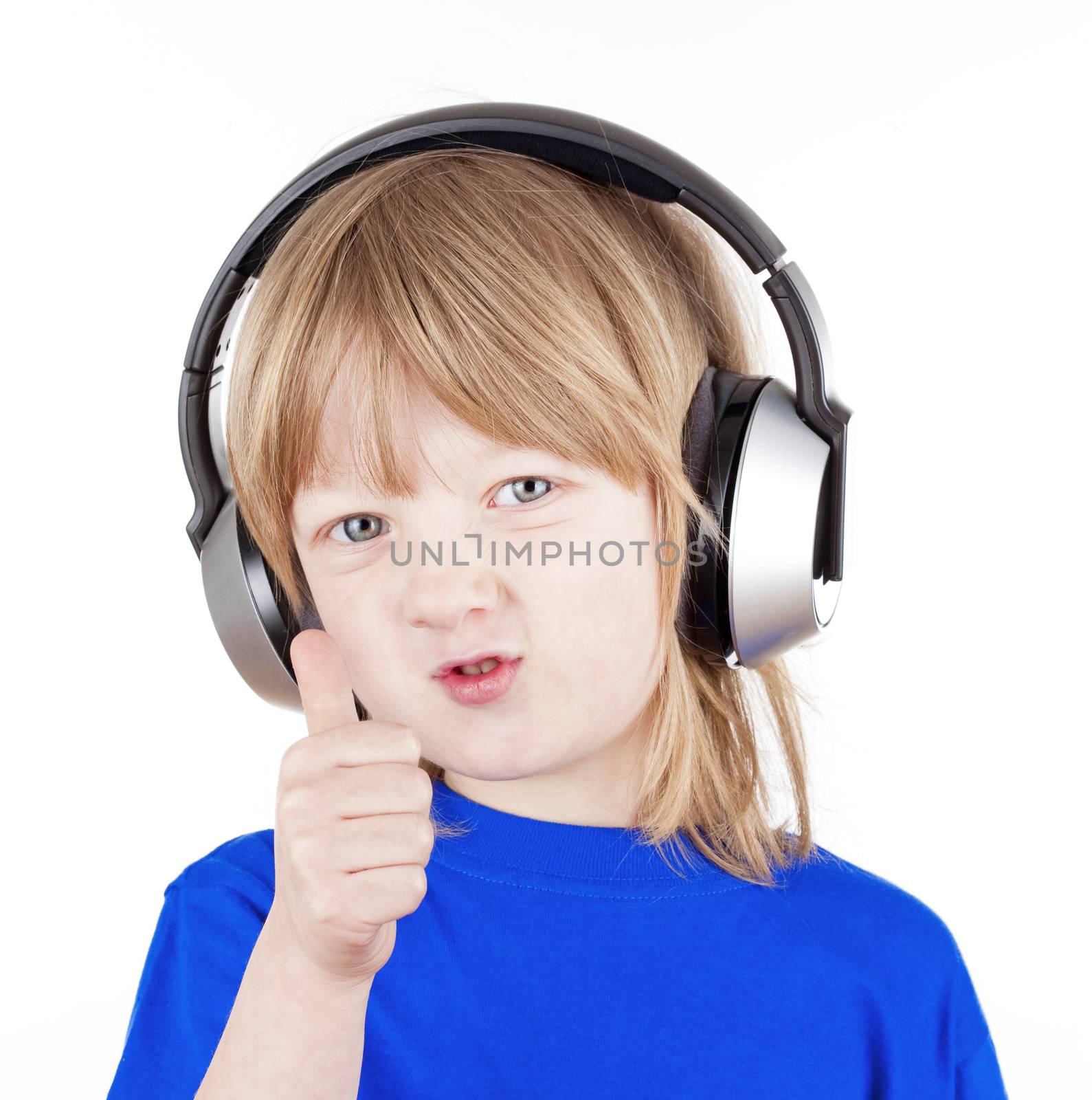 boy with long blond hair listening to music in headphones - isolated on white