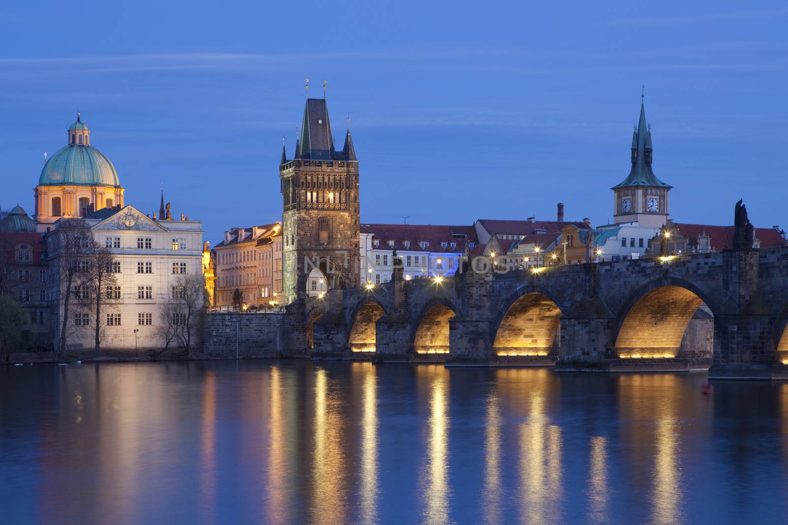 czech republic, prague - charles bridge and spires of the old town at dusk