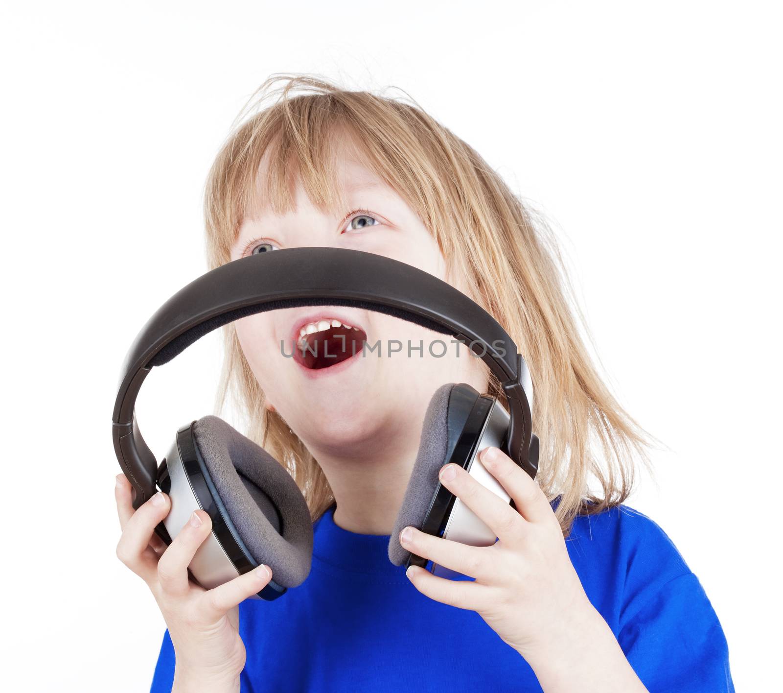 boy with long blond hair listening to music in headphones - isolated on white