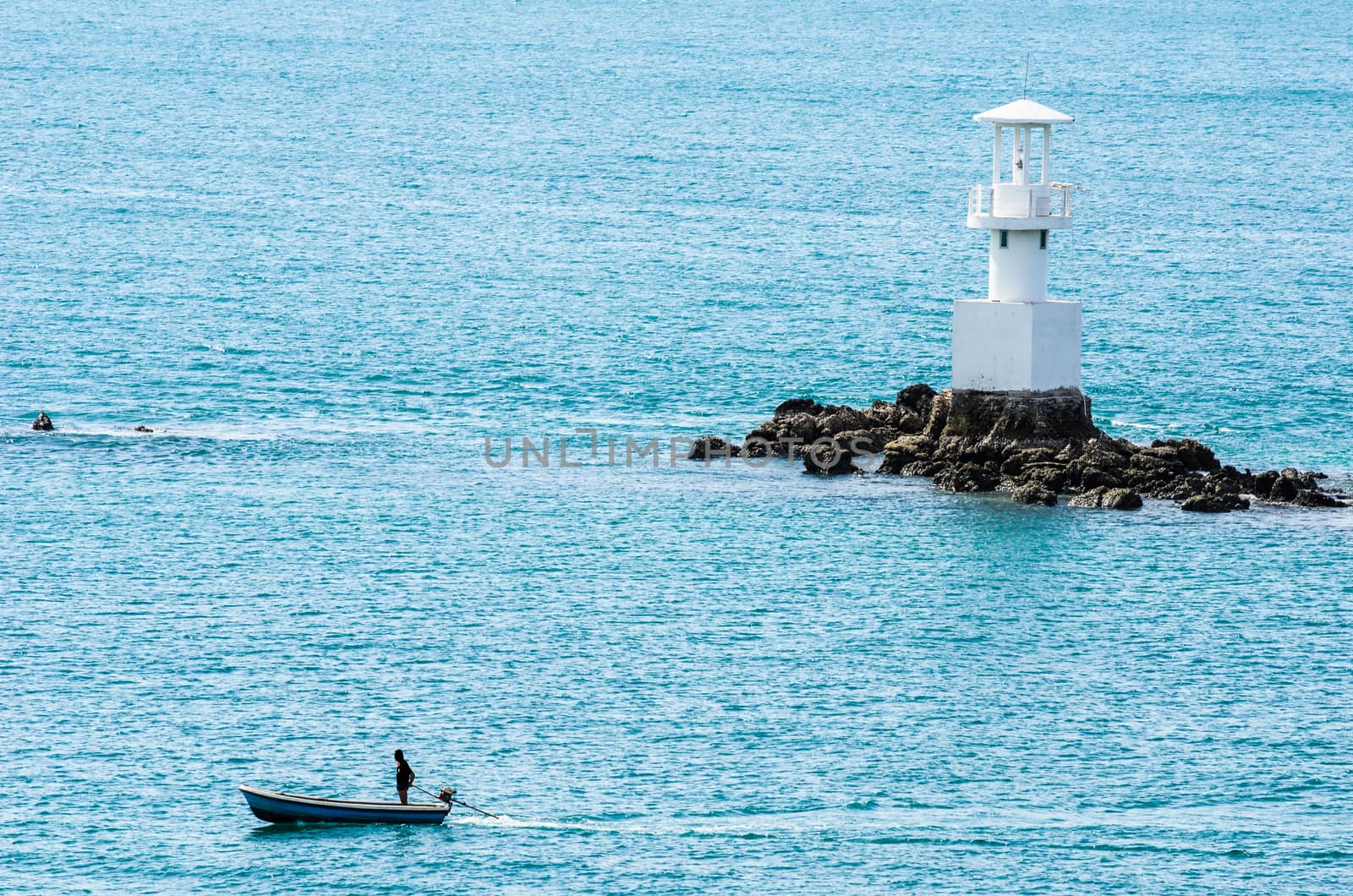 White Lighthouse on the sea and blue sky in Thailand