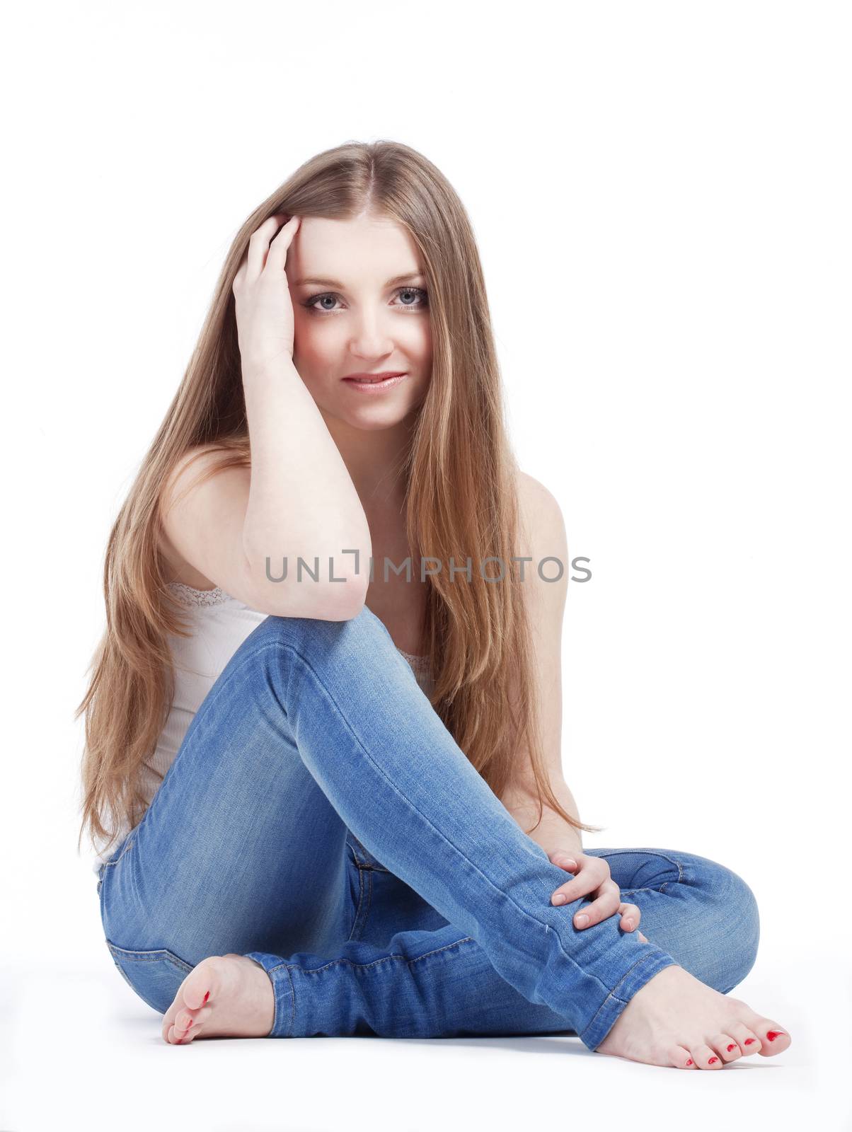 portrait of a young girl with long hair sitting, looking- isolated on white