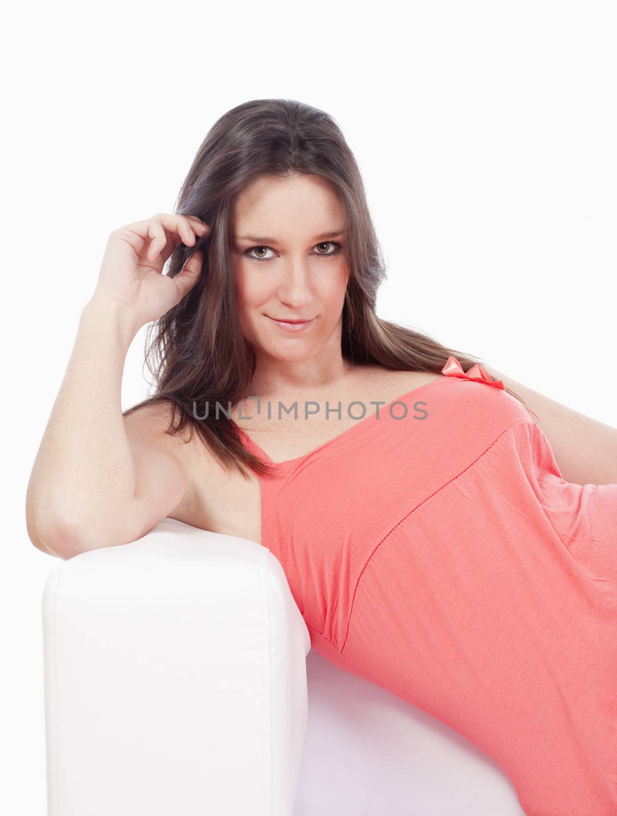 portrait of a young woman with dark hair sitting on sofa