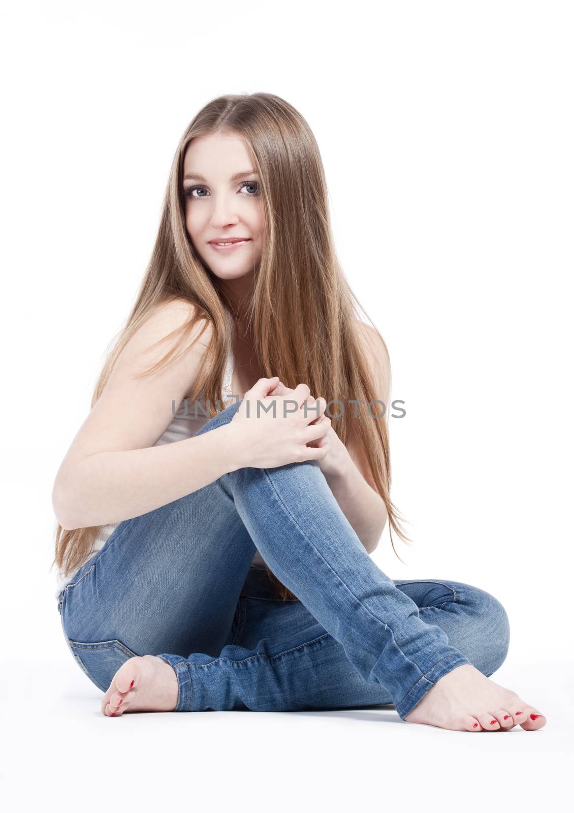 portrait of a young girl with long hair sitting, looking- isolated on white