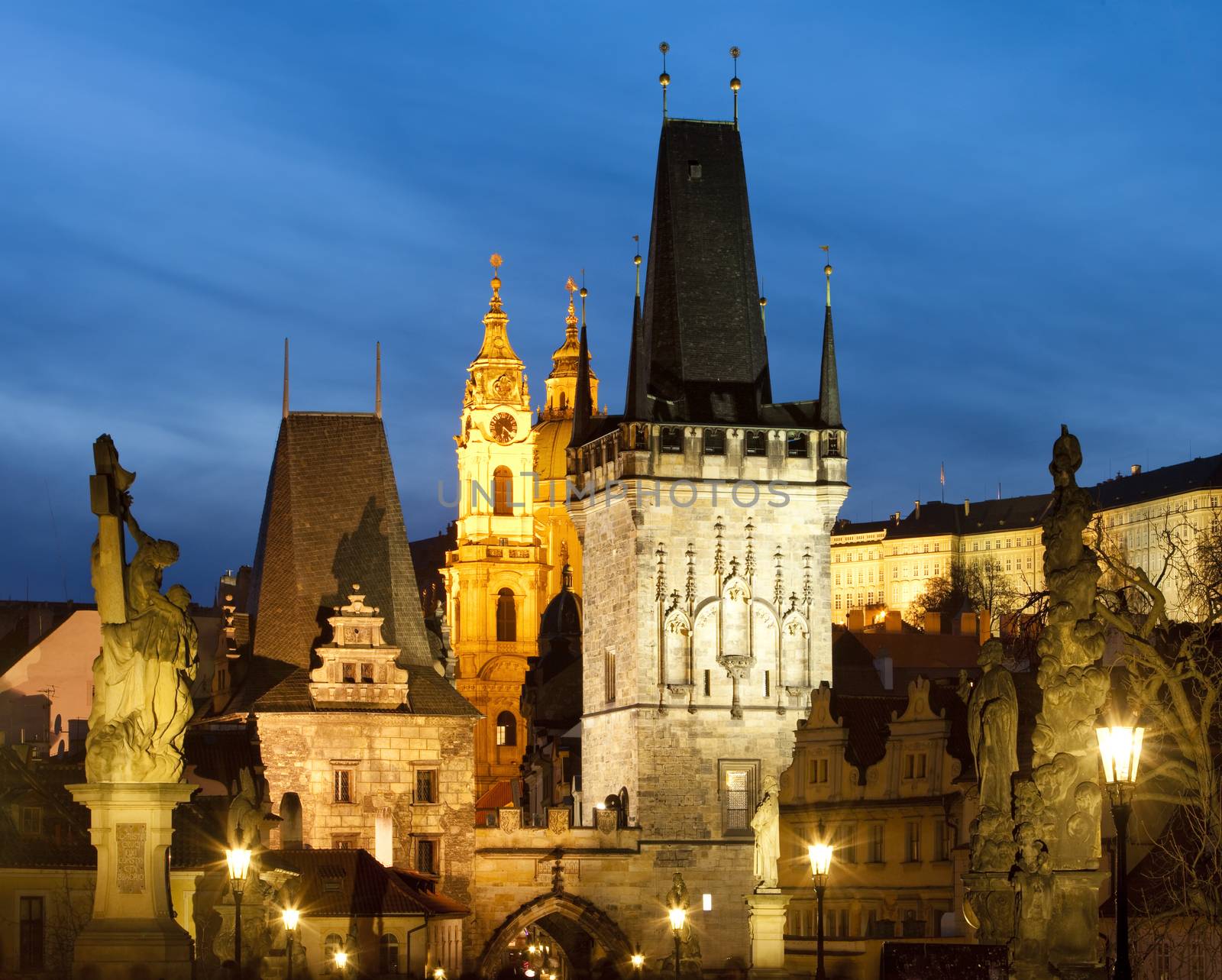 czech republic prague - charles bridge tower and st. nicolau church at dusk