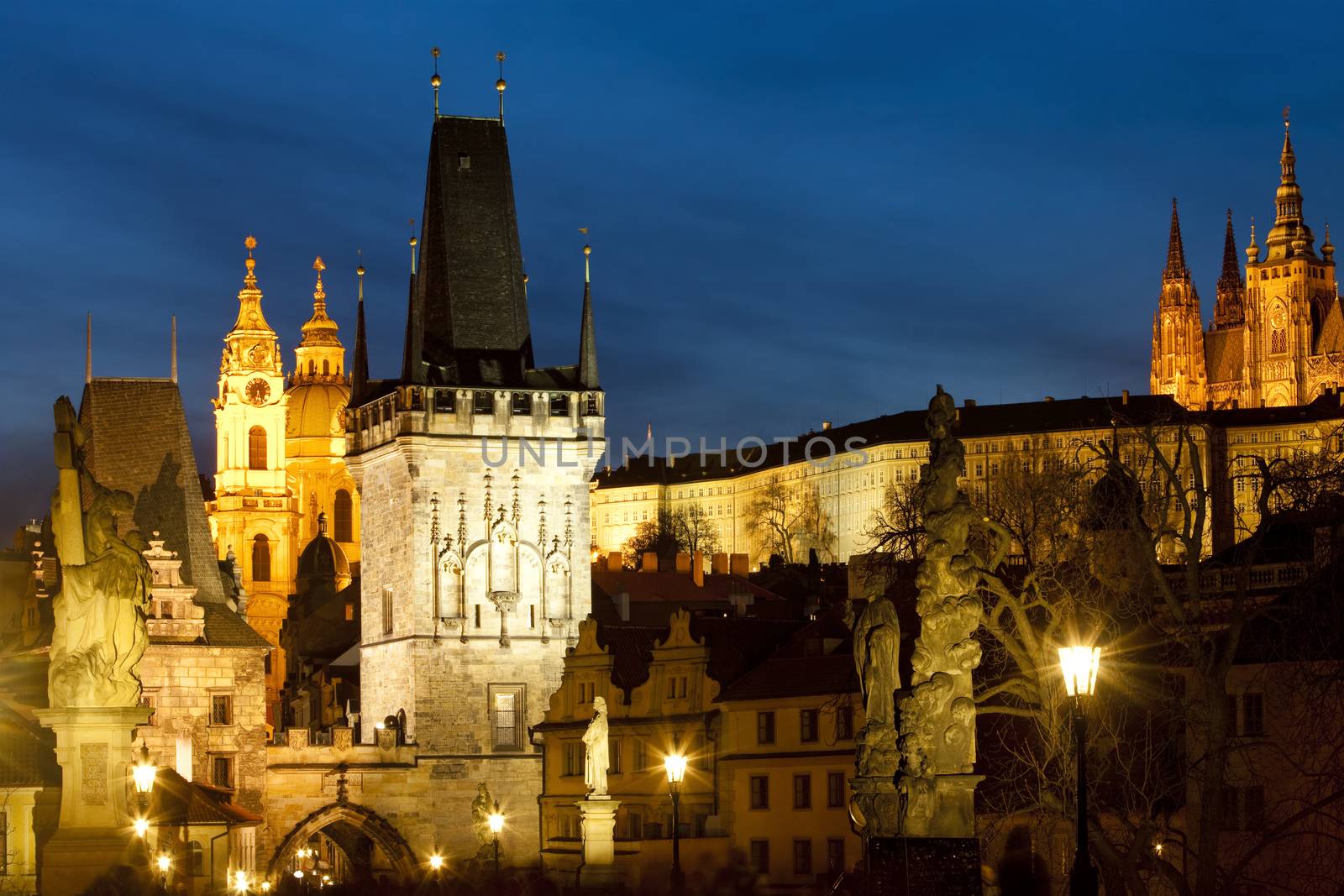 czech republic prague - charles bridge tower and st. nicolau church at dusk