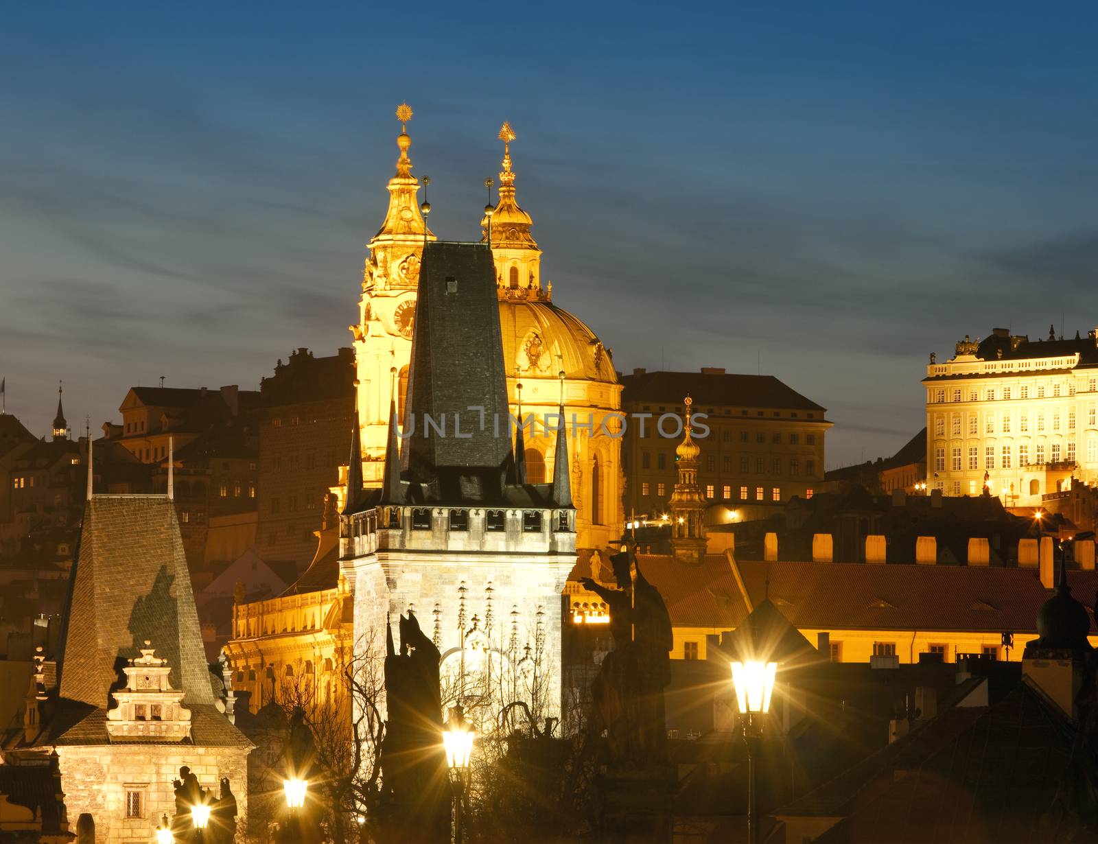 czech republic prague - charles bridge tower and st. nicolas church at dusk