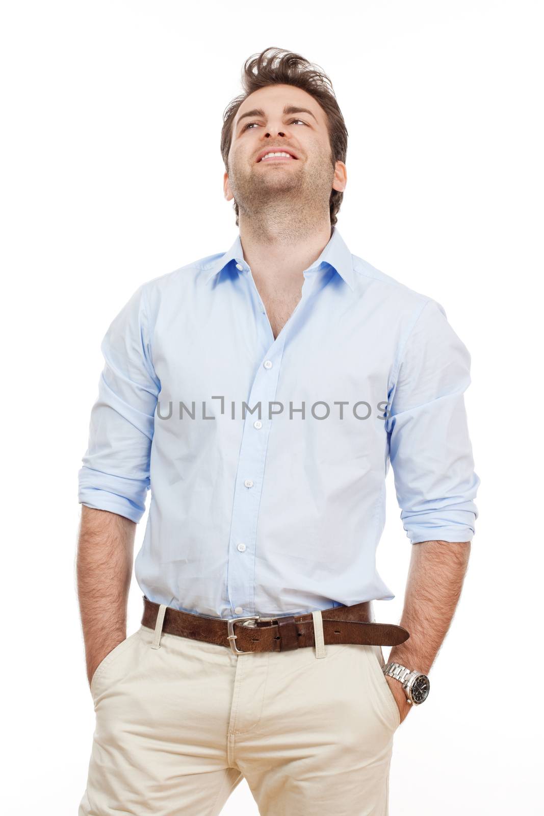 man in blue shirt and light trousers standing, looking - isolated on white