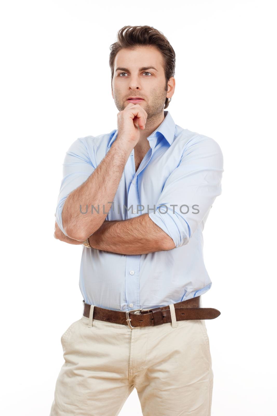 man in blue shirt and light trousers standing, thinking - isolated on white