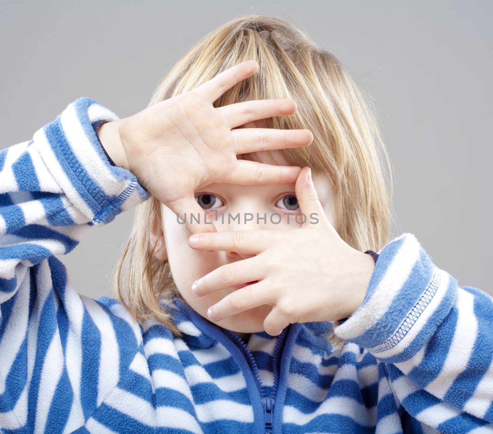 boy looking through finger frame by courtyardpix