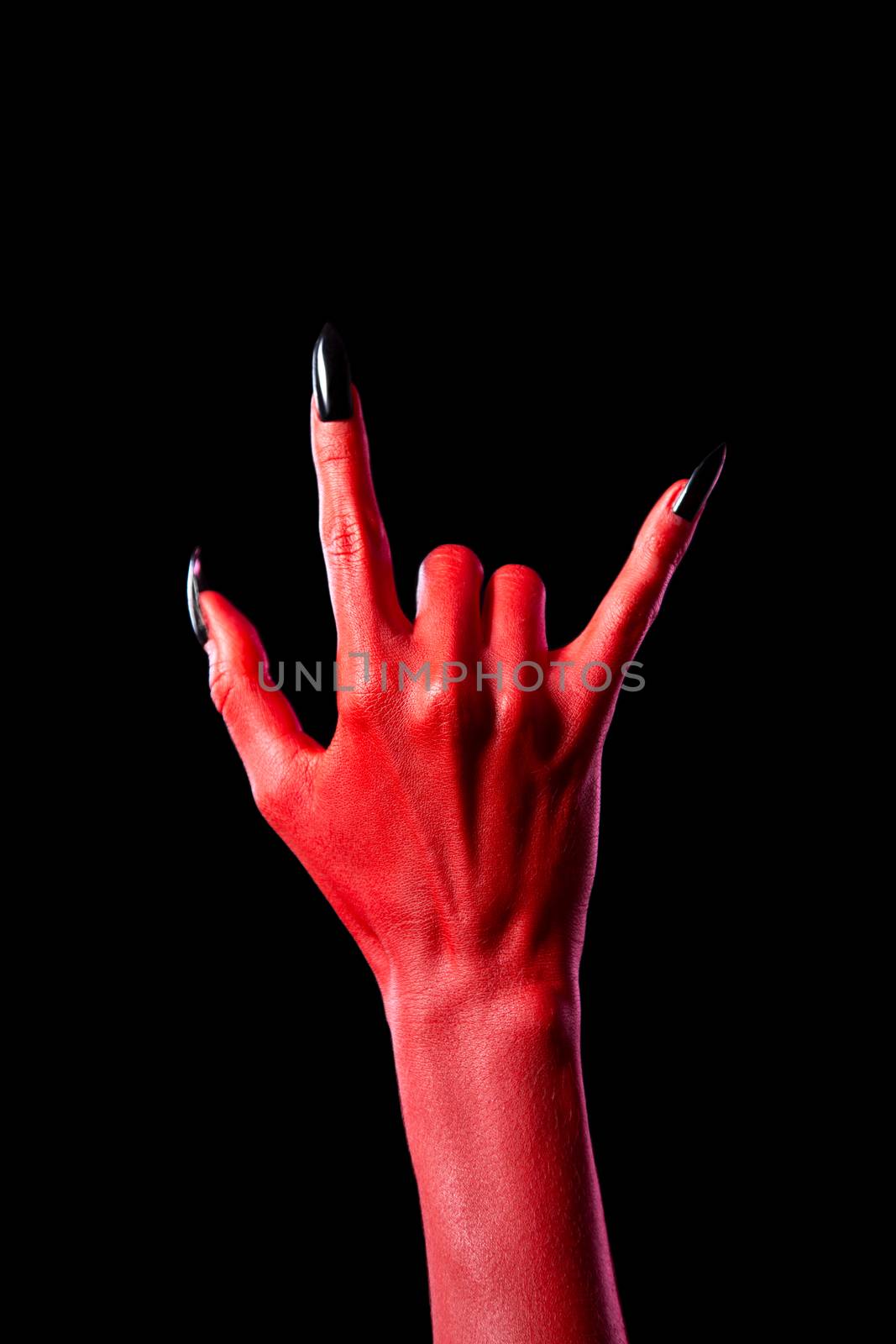 Devil hand showing heavy metal gesture, isolated on black background  