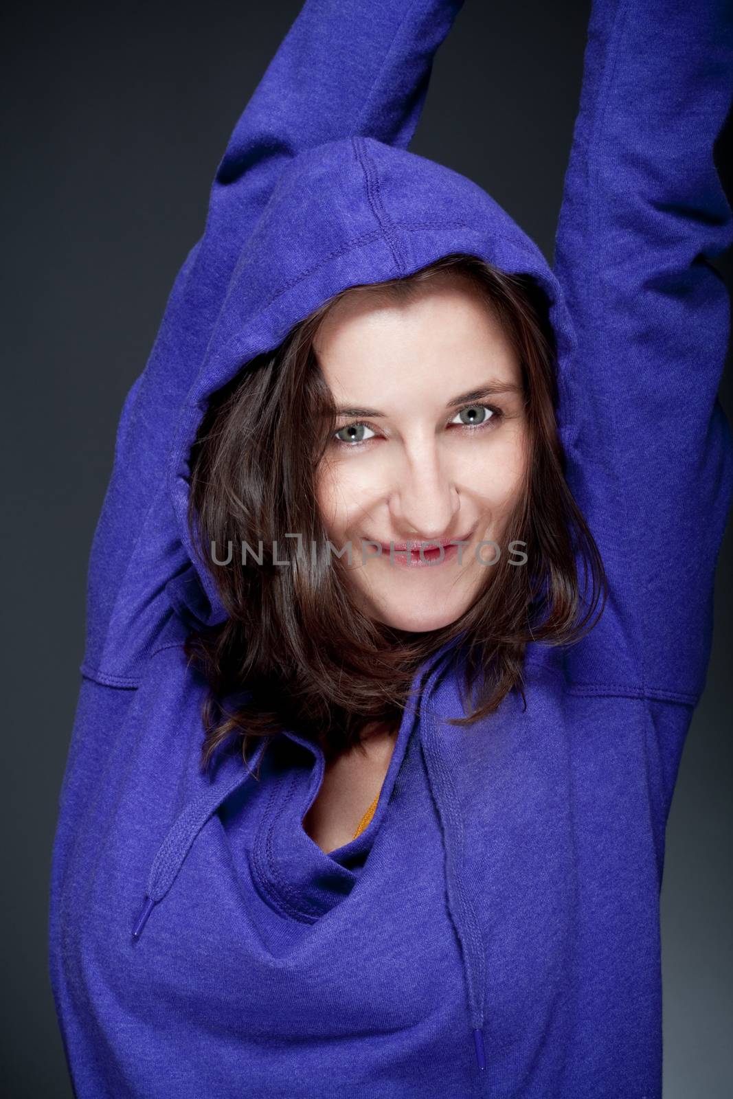 portrait of beautiful woman with brown hair smiling - gray background