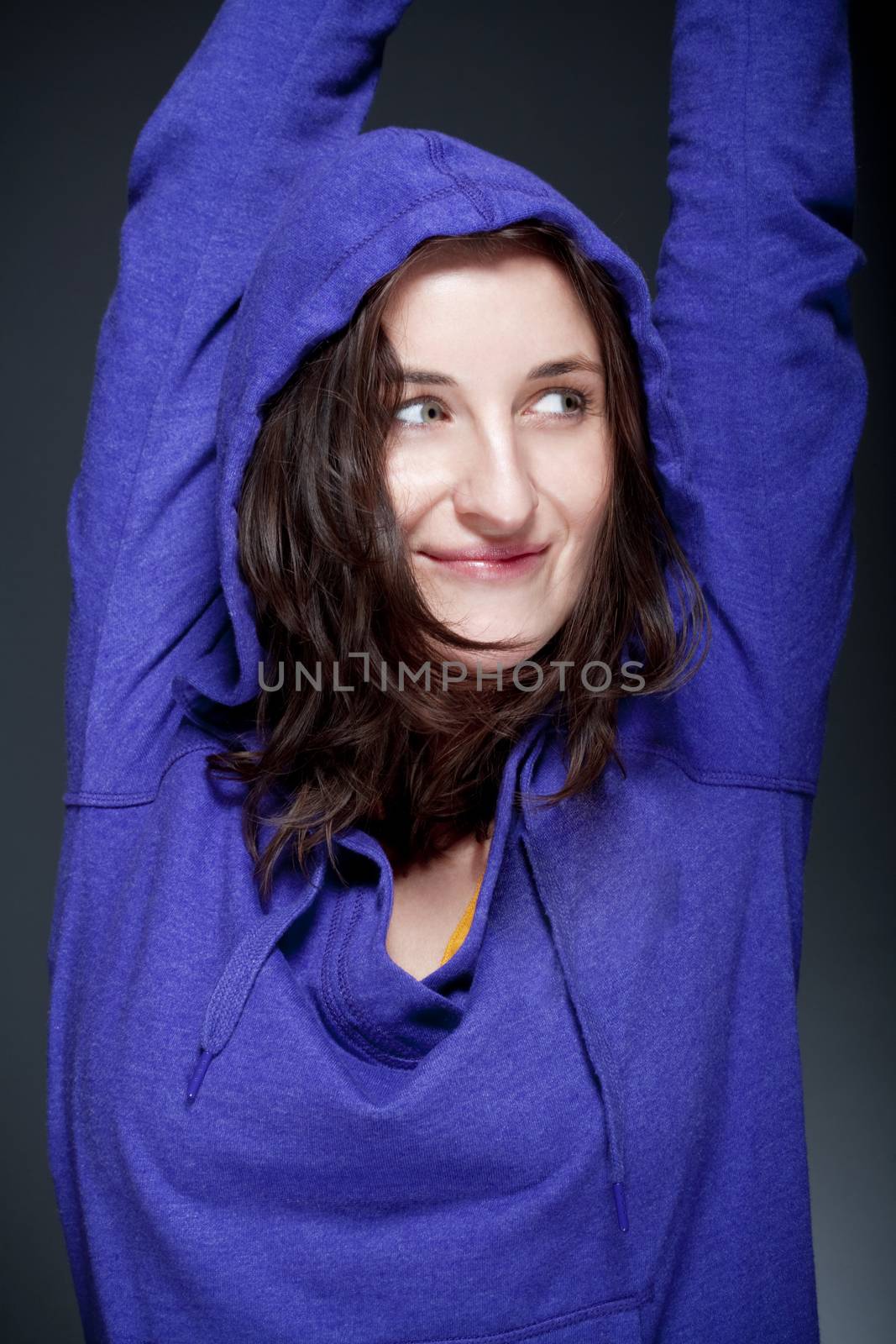 portrait of beautiful woman with brown hair smiling - gray background