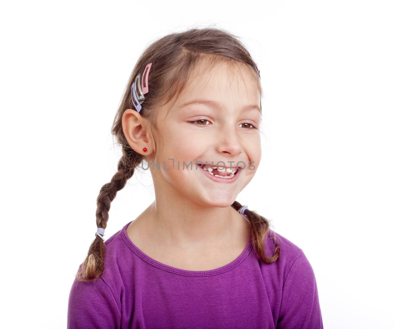 portrait of a little girl with braids smilig - isolated on white