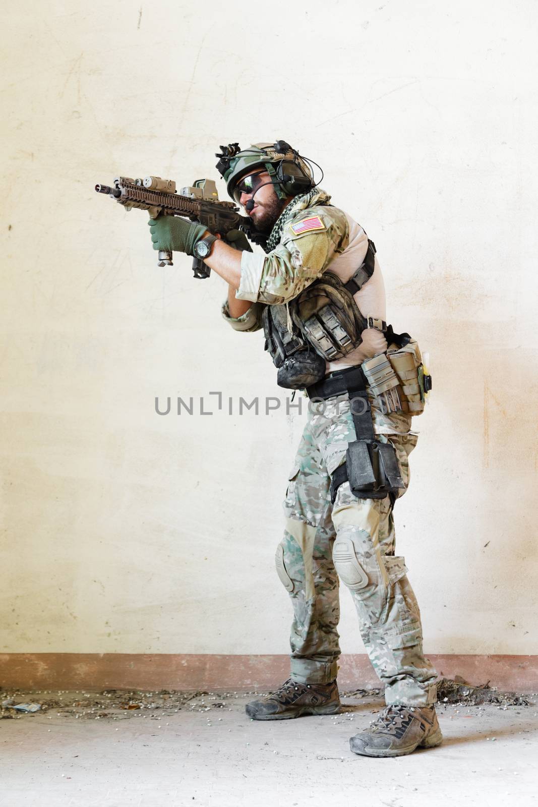 american soldier pointing his rifle during the military operation
