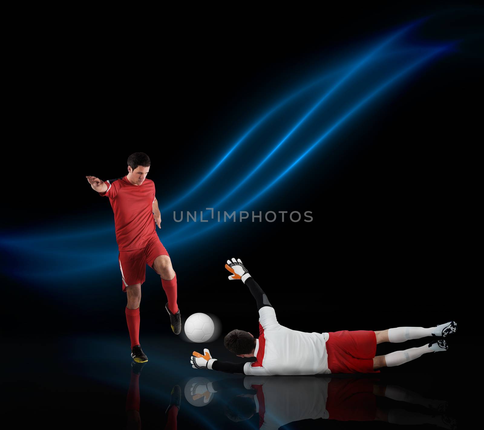 Football players tackling for the ball on black background with lights