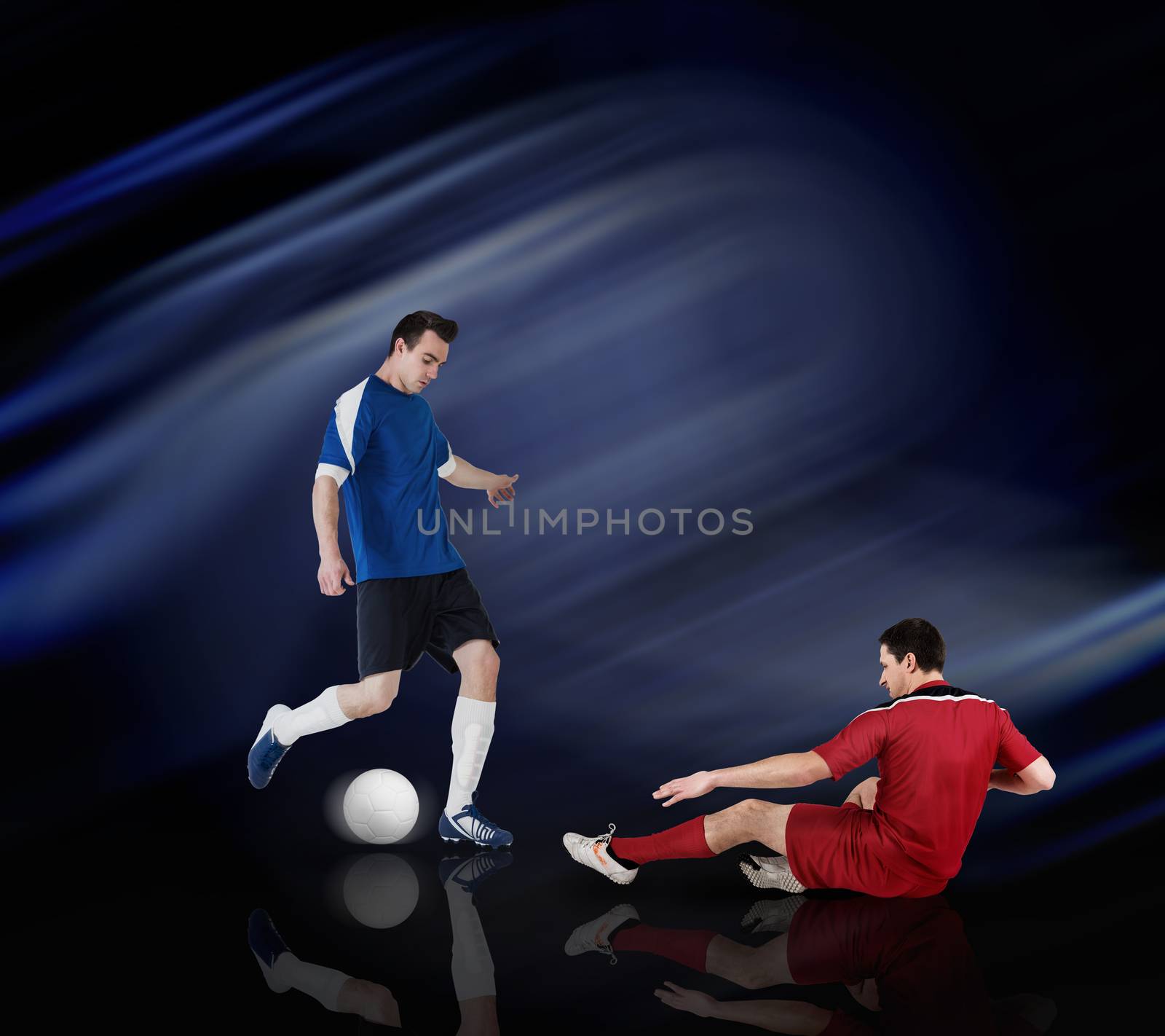 Football players tackling for the ball by Wavebreakmedia