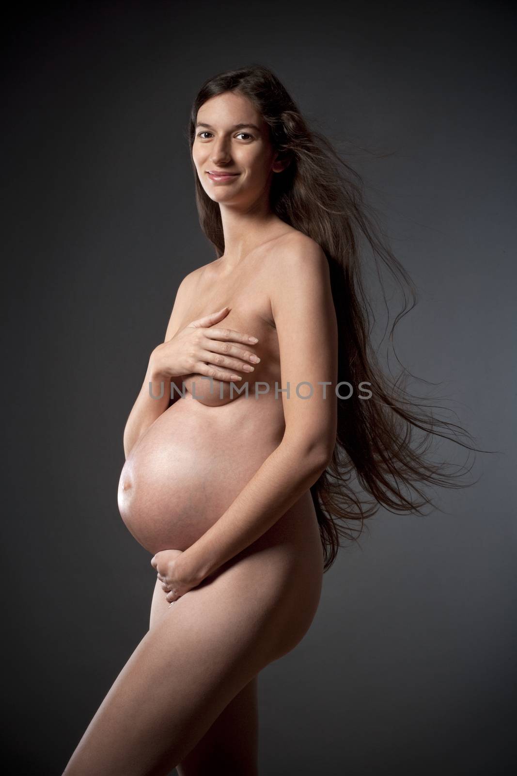 nude pregnant woman with very long brown hair