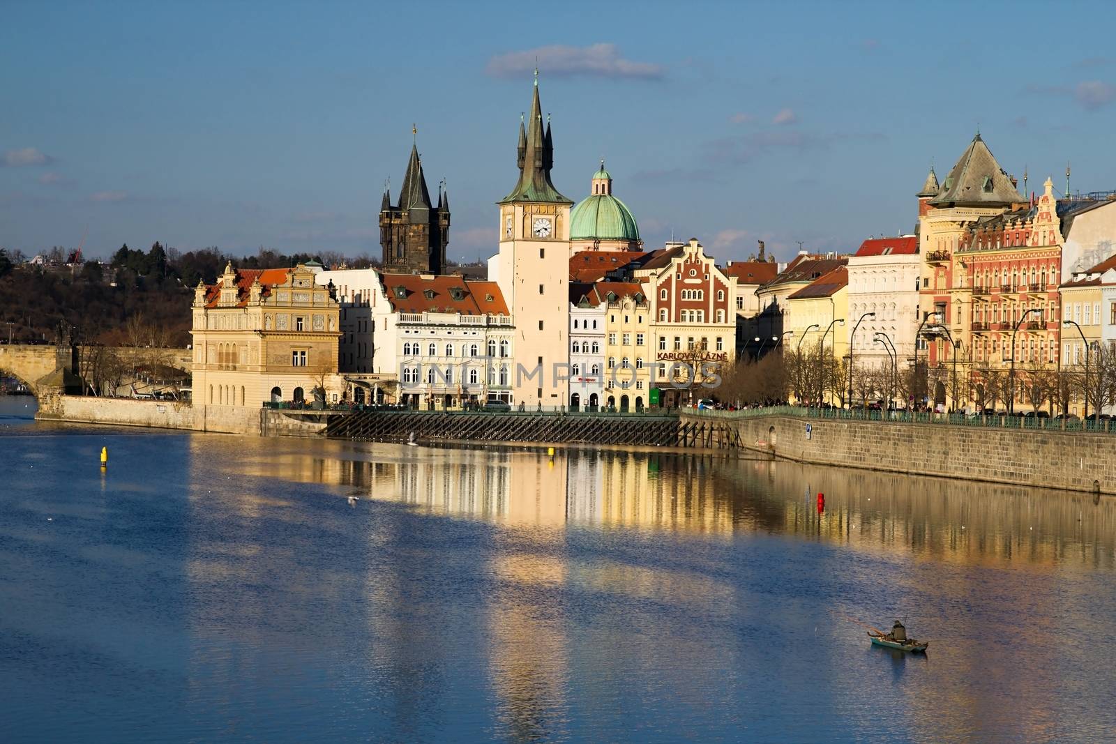 Photo shows various historical houses, Vltava river, bridges and other architectural details.