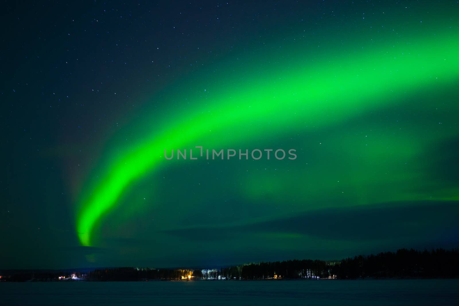Intense northern lights - Aurora borealis over Lake in Finland