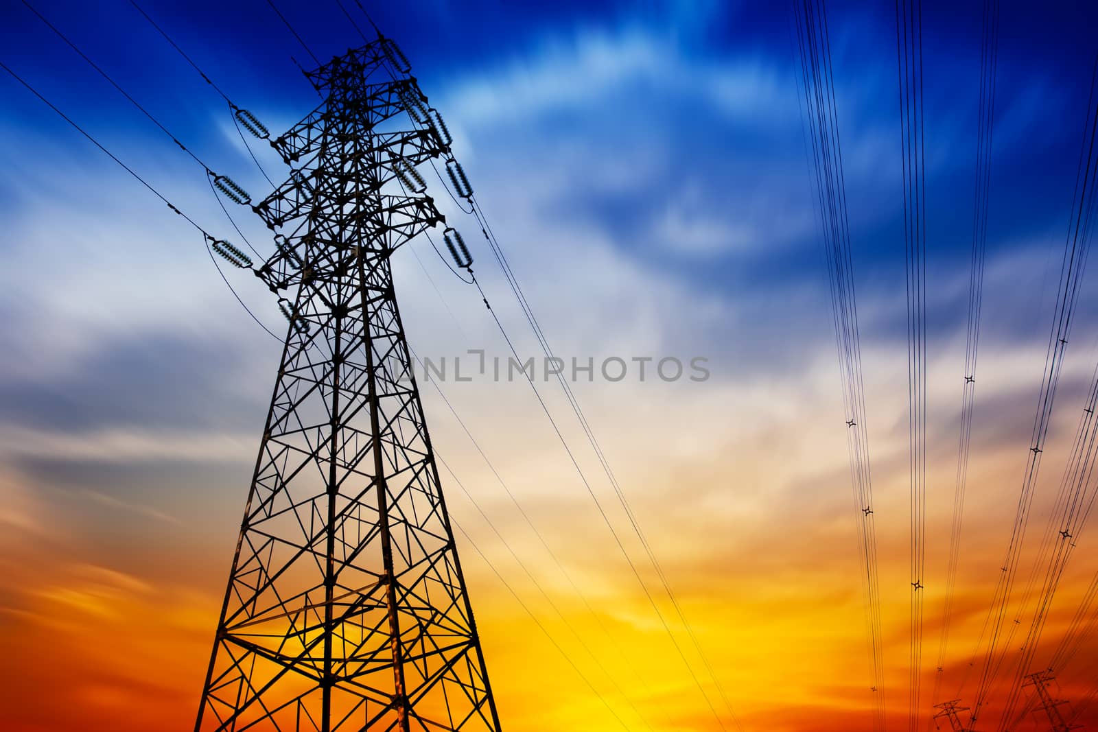 High voltage tower at sunset