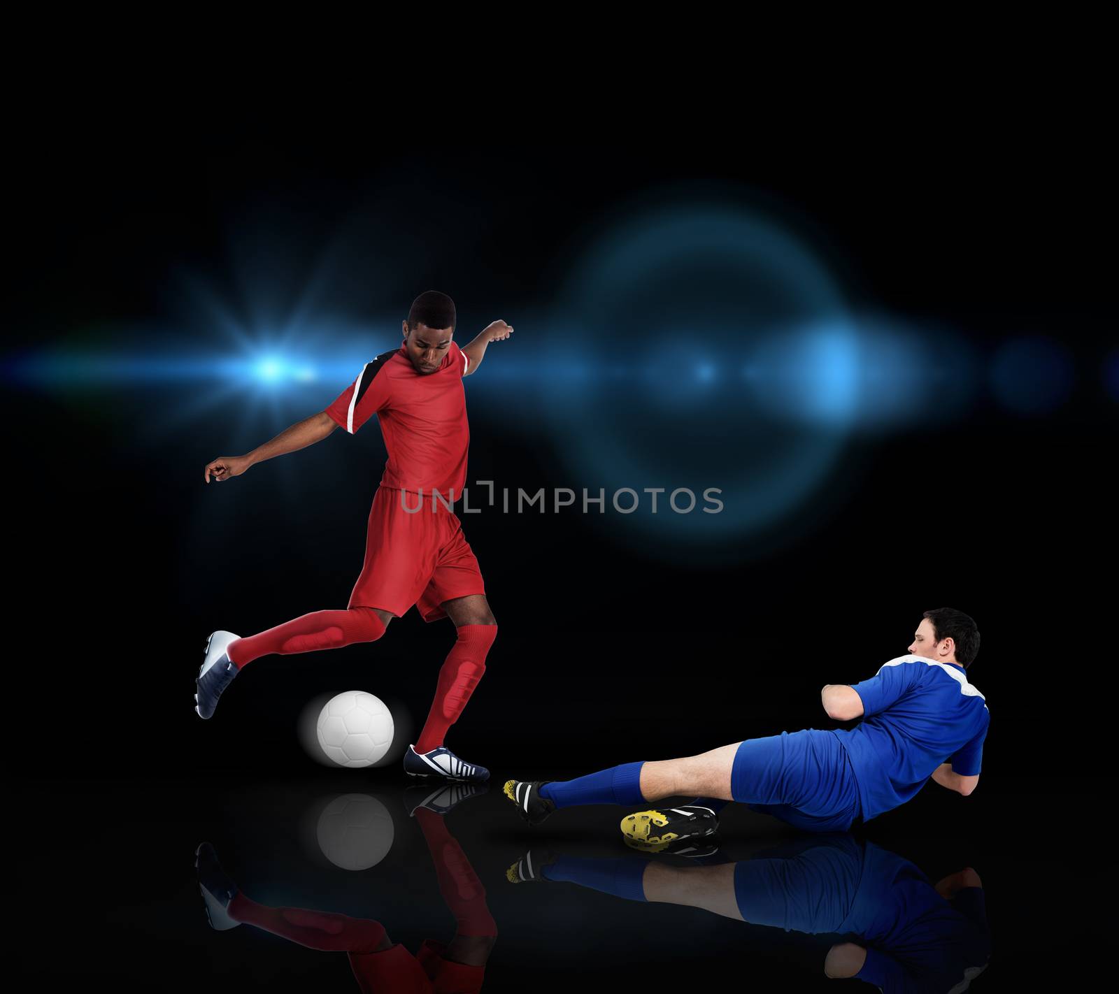 Football players tackling for the ball by Wavebreakmedia