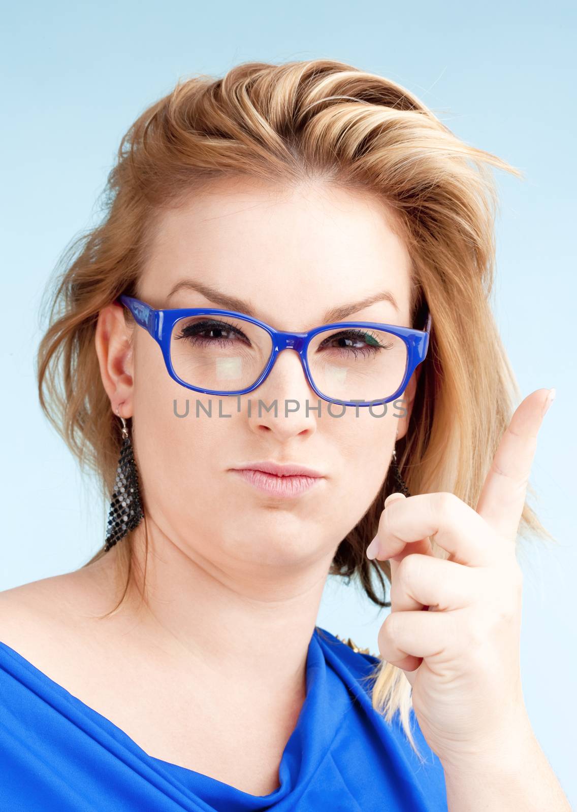 Young Woman with Blond Hair and glasses Lifting her Finger