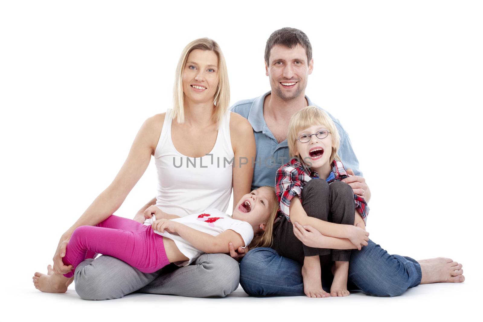 happy parents with their two children looking at the camera, smiling - isolated on white