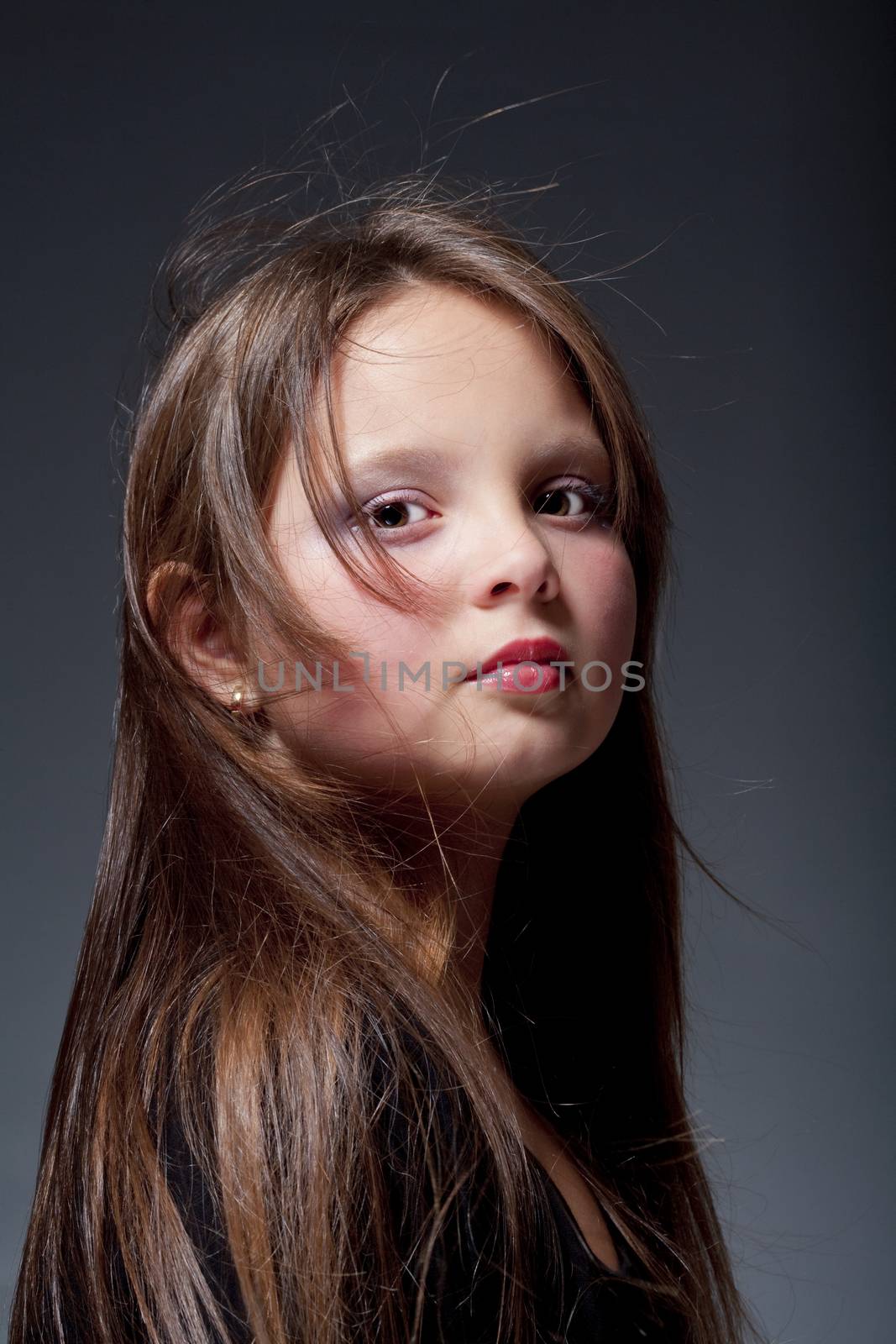 portrait of a twelve years old girl with brown eyes and long hair