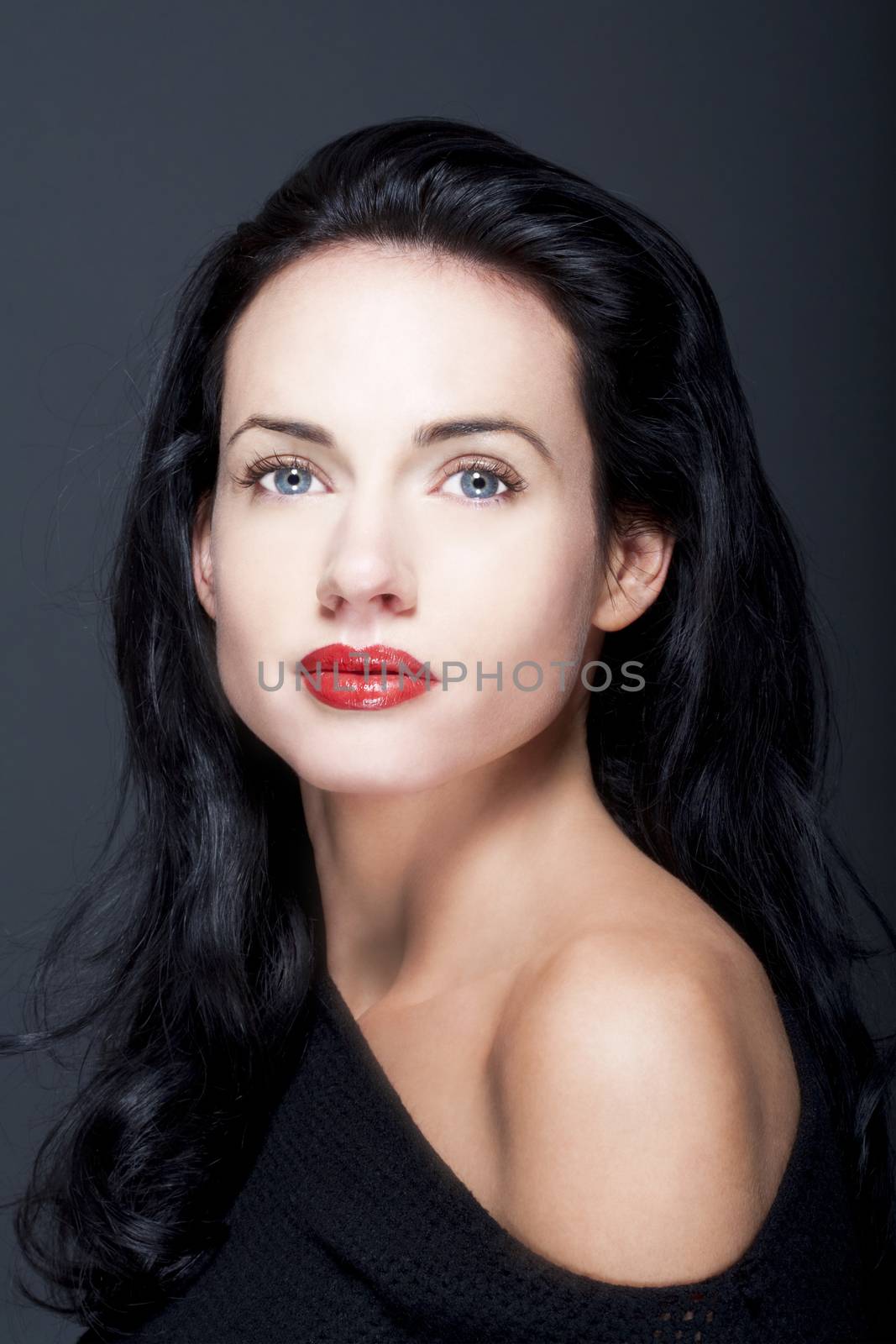 portrait of beautiful woman with dark hair and blue eyes