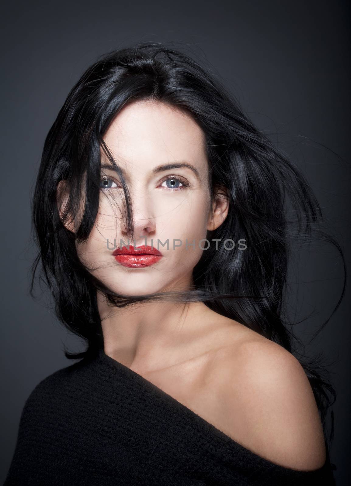 portrait of beautiful woman with dark hair and blue eyes