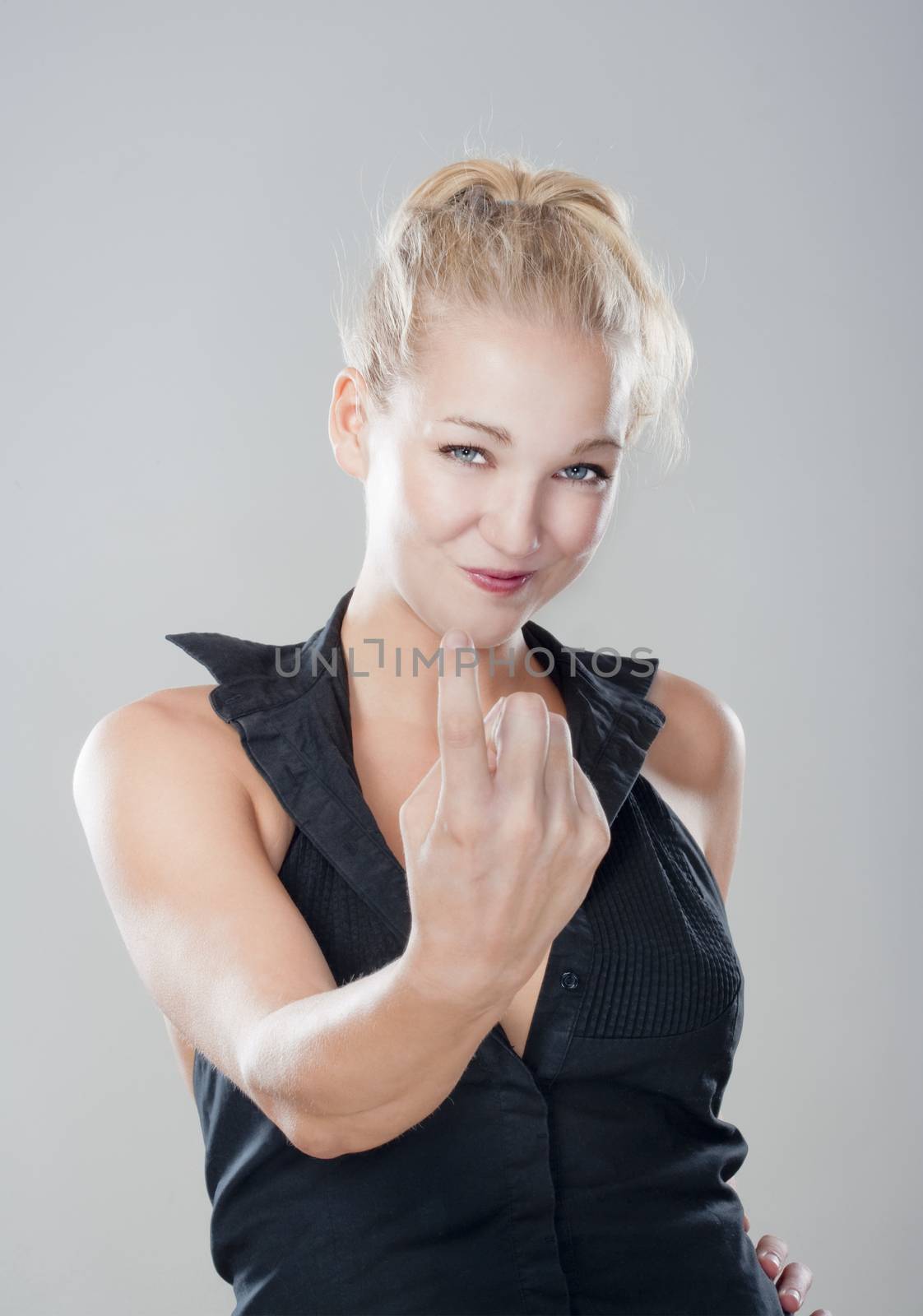 sexy blond girl showing come on gesture looking, smiling - isolated on gray