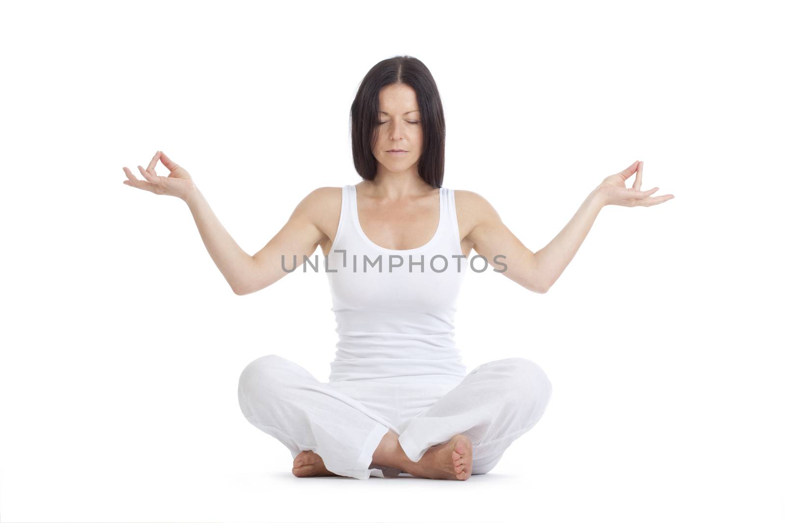 woman sitting on the floor exercising yoga - isolated on white