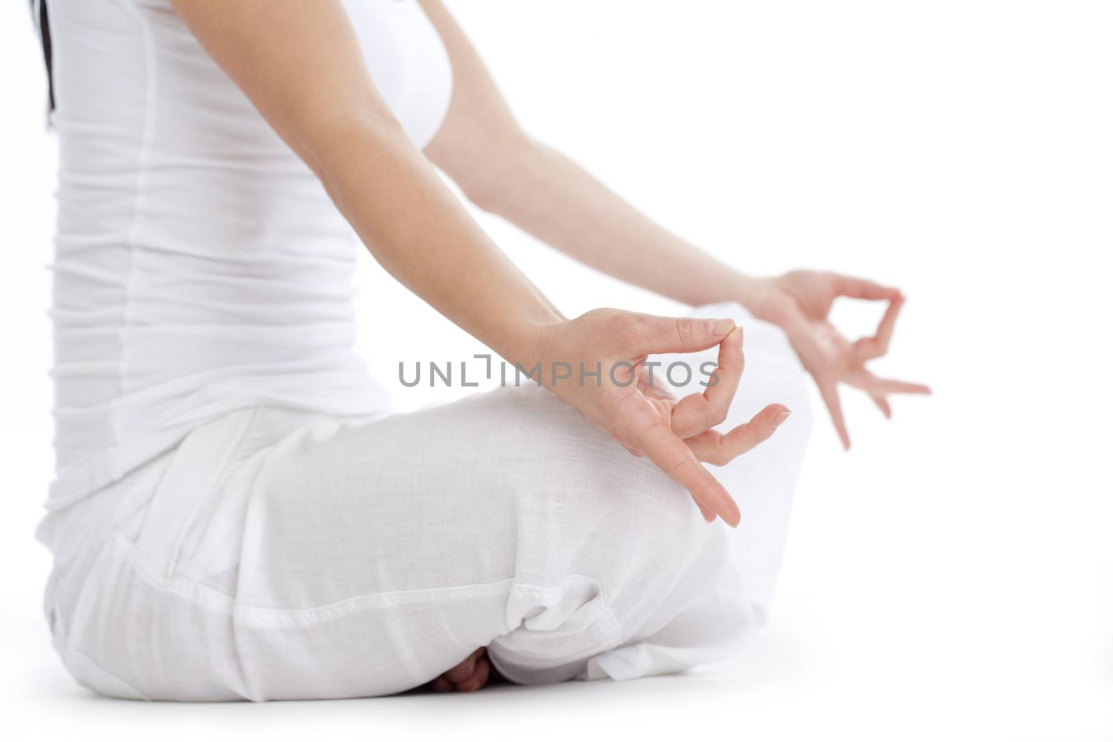 woman sitting on the floor exercising yoga - isolated on white