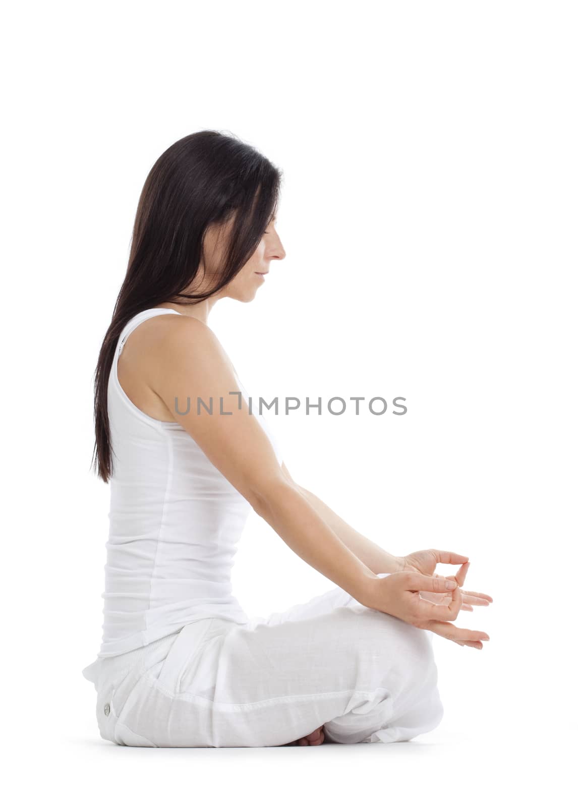 woman sitting on the floor exercising yoga - isolated on white