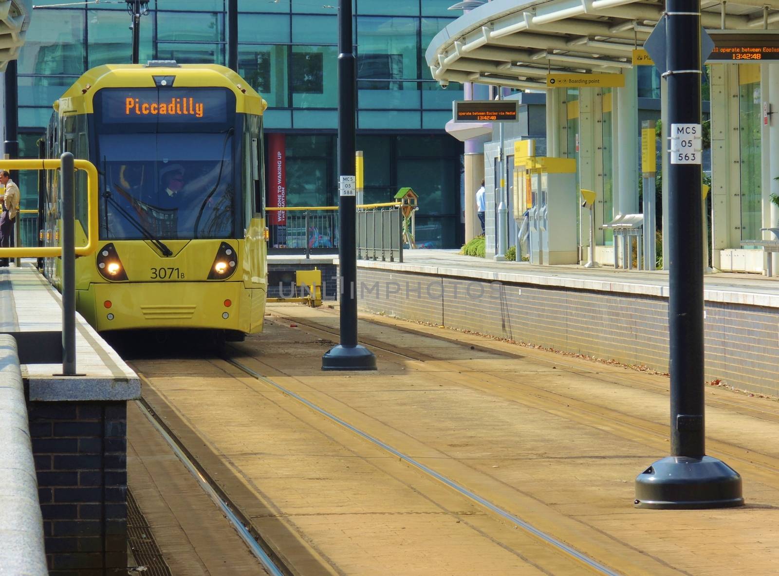 A yellow Tram waiting at Media City station, Salford Quays, UK.