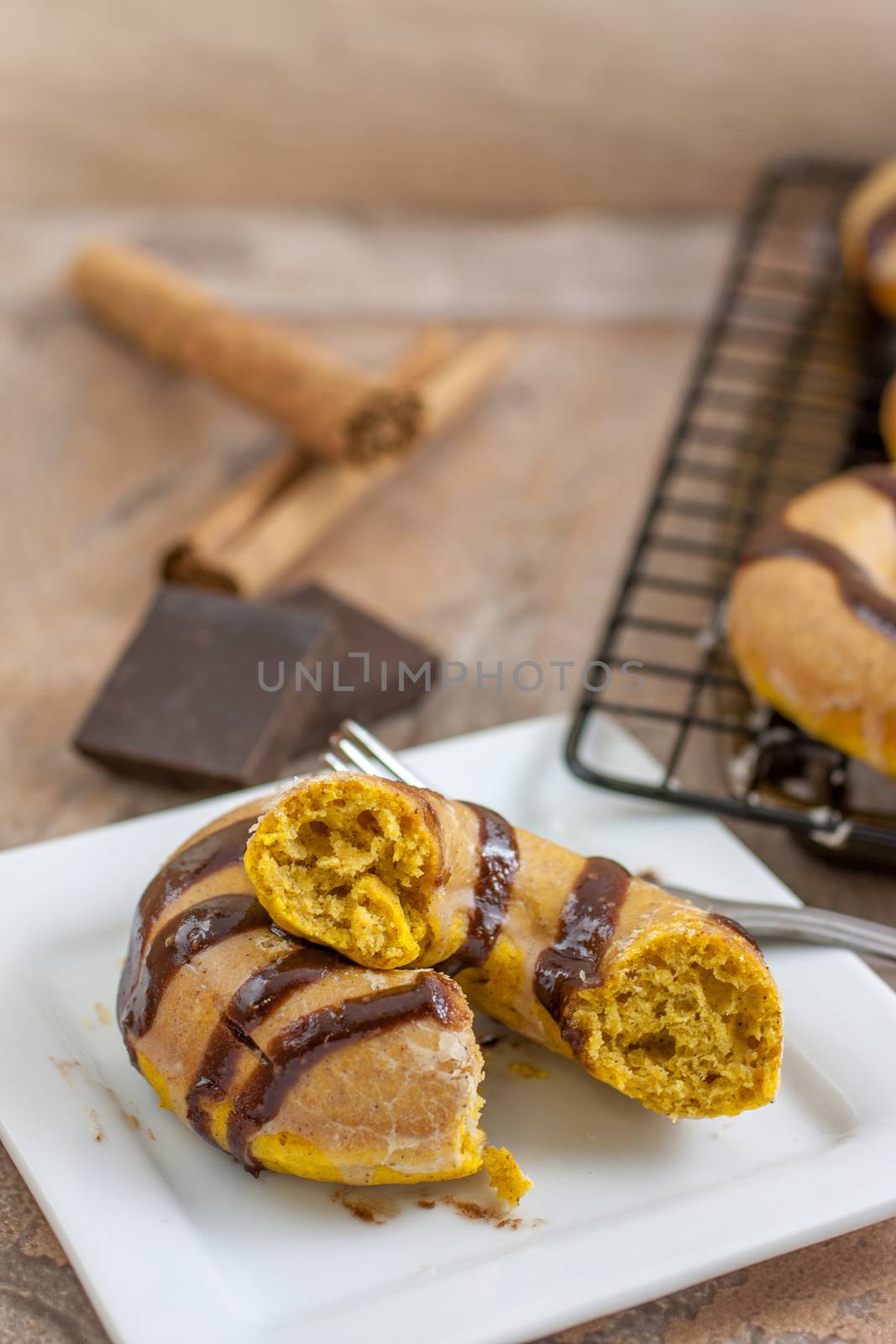 Pumpkin doughnuts with spiced glaze and choclate drizzle over the top.