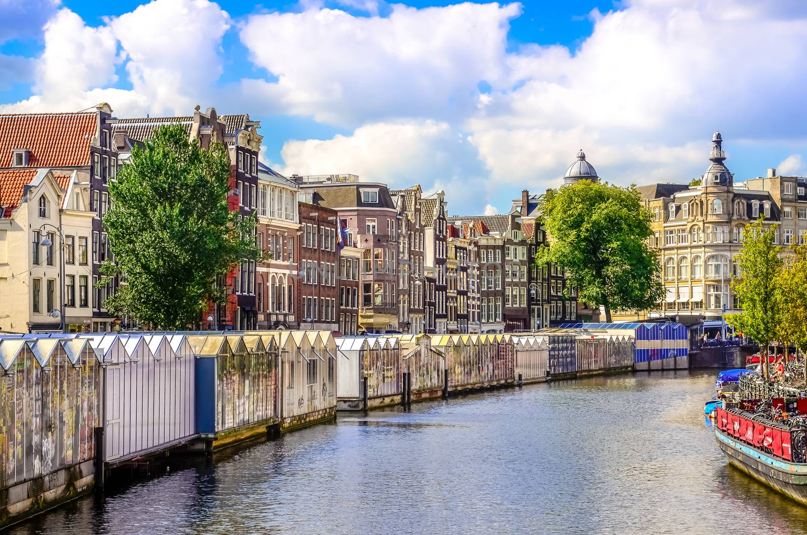 Scenic view of canal in Amsterdam at flower market by martinm303