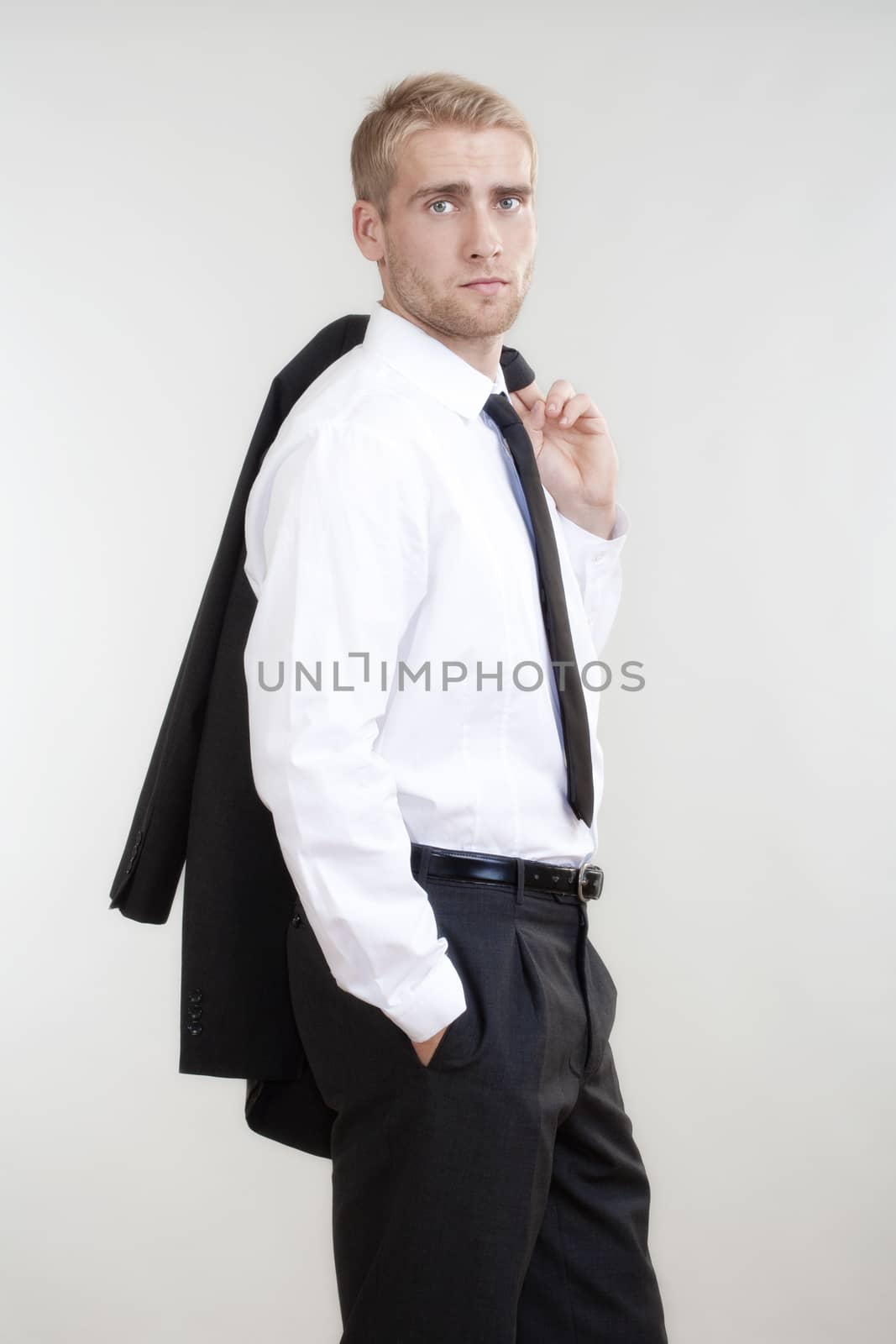 portrait of a young businessman with blond hair standing - isolated on white