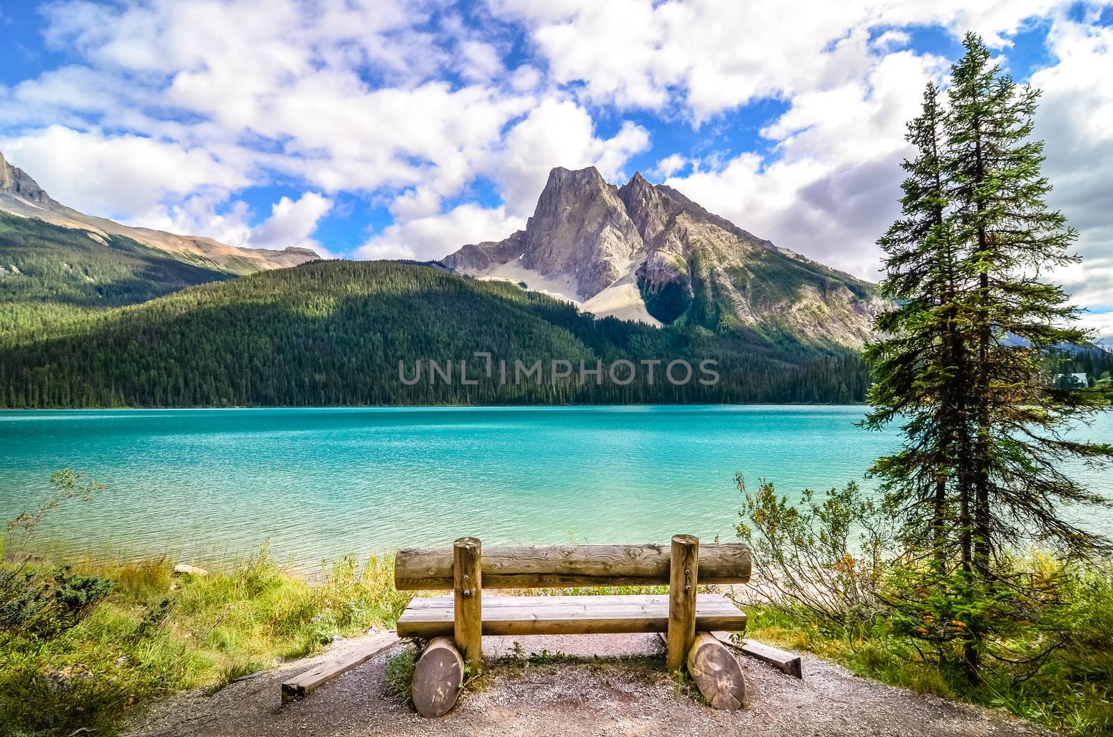 Scenic view of mountain lake and wooden bench by martinm303