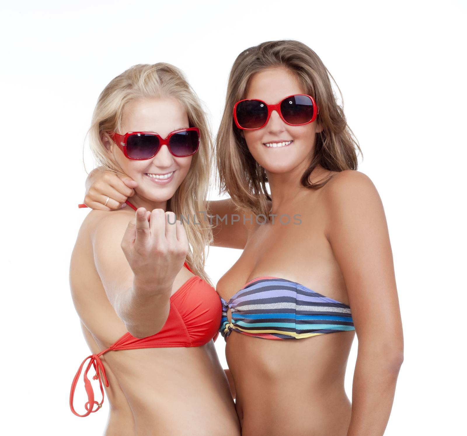 two young beautiful women in bikini tops showing come on gesture - isolated on white