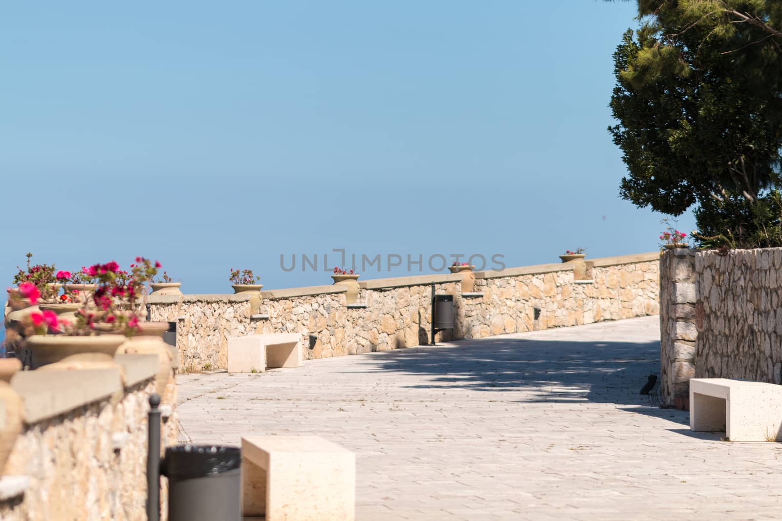 Narrow street with stone wall