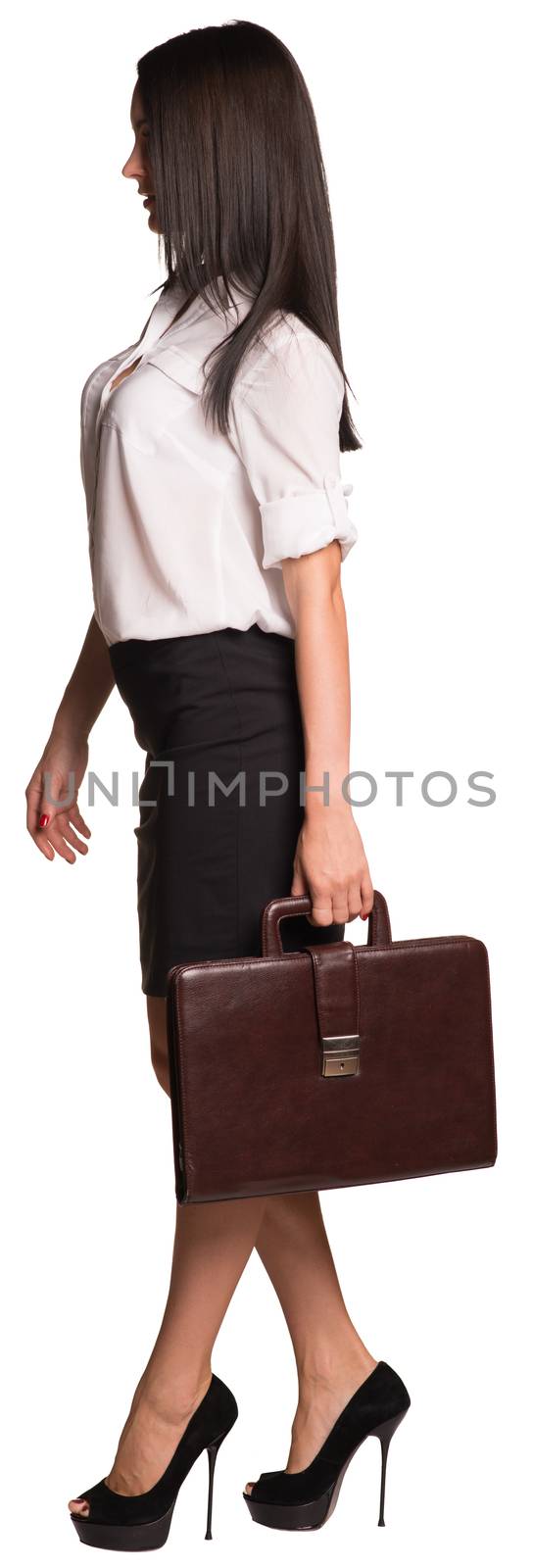 Beautiful businesswomen in blouse and skirt walks forward. Hold briefcase. Isolated on white background