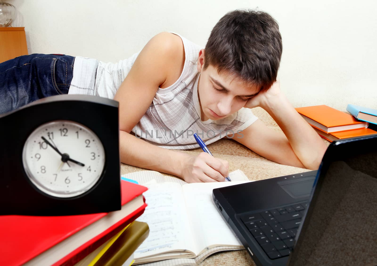 Teenager preparing for Exam in the Night at the Home