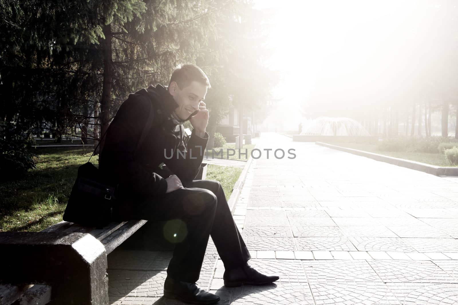 Young Man with Cellphone outdoor by sabphoto