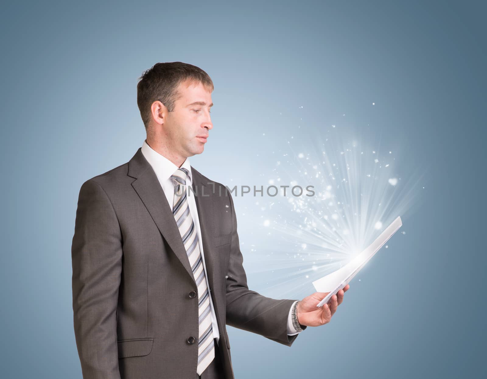 Businessman in suit hold paper sheets. Blue background